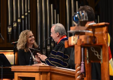 David S. Dockery, president of the university, presents the Staff of the Year award to Christy Young, coordinator of special programs and administrative assistant to the dean of the school of theology and missions, during the annual Awards Day chapel service. - Photo by Jacob Moore