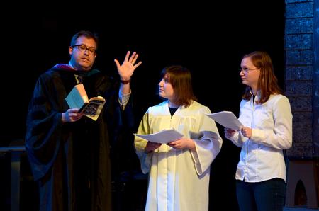 Gavin Richardson, professor of English, performs a dramatic reading of "The Fall of Lucifer" with Mary Laarz, junior English major, and Holly Owens, senior music major, during the Scholarship Symposium. - Photo by Jacob Moore