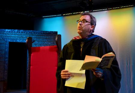 Gavin Richardson, professor of English, performs a dramatic reading of "The Fall of Lucifer" with students from his English class during the Scholarship Symposium. - Photo by Jacob Moore