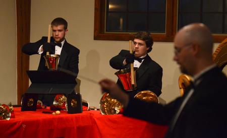 Christian Wallen, senior chemistry major, and Doug May, freshman music major, perform with the Handbell Choir at Luther Hall. - Photo by Jacob Moore