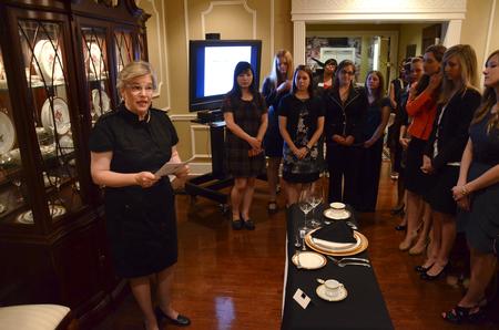 Lanese Dockery, first lady of the university, discusses the layout of utensils, glasses and plates during the 2012 Etiquette Dinner. - Photo by Jacob Moore