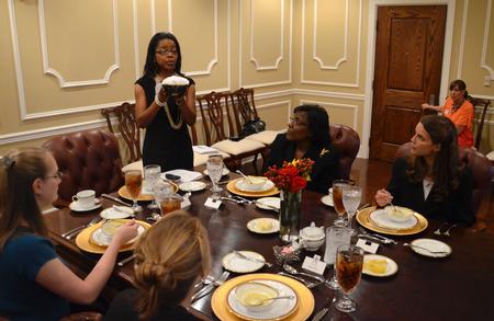 Renee Jones, associate director of the Vocatio Center for Life Calling and Career, discusses the direction items should be passed in a formal dining situation during the 2012 Etiquette Dinner. - Photo by Jacob Moore
