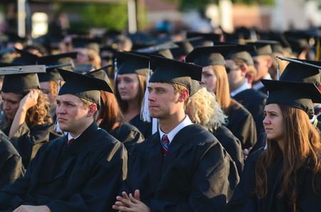Graduates Alex Brown and Josh Brown, both journalism, and Chelsea Carrier, English, listen to the commencement address during spring graduation.
 - Photo by Zac Calvert