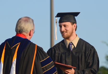 Colby Stinebaugh, art graduate, receives his diploma from David S. Dockery, president of the university, during spring graduation. 
 - Photo by Zac Calvert