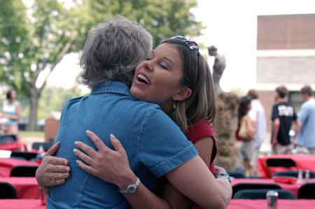 Graduate Jennifer Blackwell gives Pam Sutton a big hug after the graduate luncheon. - Photo by Kristen Hiller