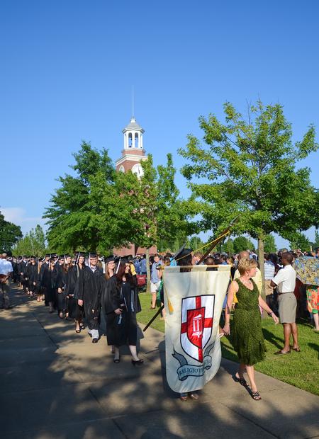 Spring graduates of the 2012 class walk in procession beside the Great Lawn before the commencement services begin. - Photo by Zac Calvert