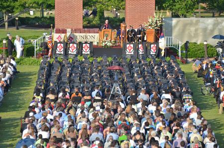 David S. Dockery, president of the university, welcomes graduates, employees, and guests to spring graduation in front of Miller Tower. - Photo by Morris Abernathy
