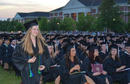 Katherine Pullen, an intercultural studies and journalism double major from Jacksonville, Fla.,  makes her way to the stage to receive the Elizabeth Tigrett Medal. - Photo by Morris Abernathy
