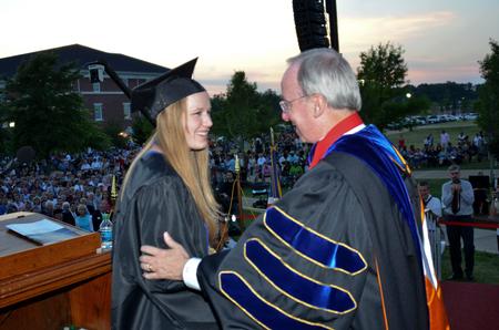 David S. Dockery, president of the university, presents the Elizabeth Tigrett Medal to Katherine Pullen, intercultural studies and journalism double major. - Photo by Morris Abernathy