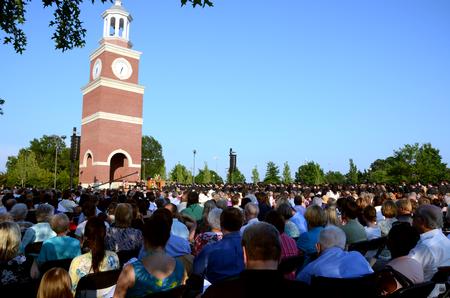 Students, family, faculty and staff gather on the great lawn to celebrate spring graduation.  - Photo by Anne Richoux