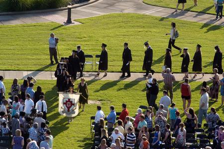 Meredith Gunn, president of the senior class, leads her fellow graduates in the processional to spring graduation. - Photo by Kristi McMurry Woody
