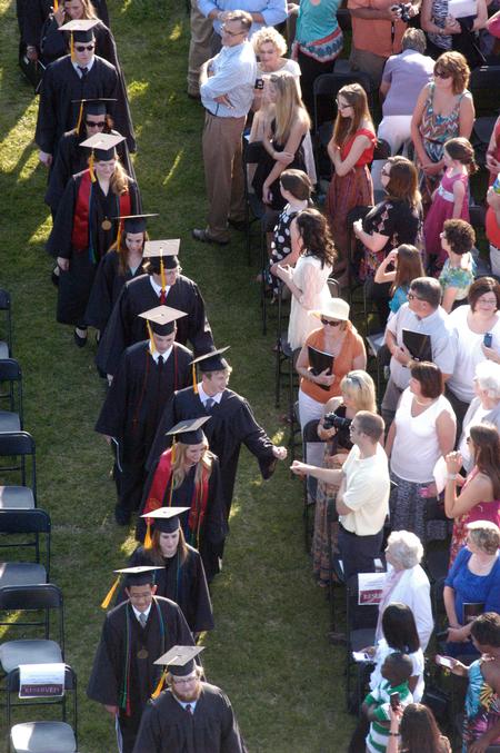 Graduates greet their friends and family as they file into spring graduation on the Great Lawn. - Photo by Kristi McMurry Woody