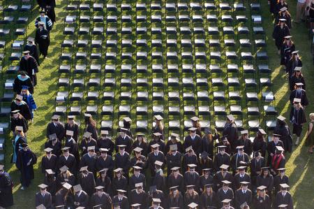 Spring graduates find their seats before the services begin on the Great Lawn on a beautiful summer evening. - Photo by Kristi McMurry Woody