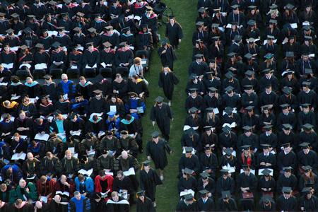Graduates file up to the stage to receive their diplomas at spring graduation. - Photo by Kristi McMurry Woody