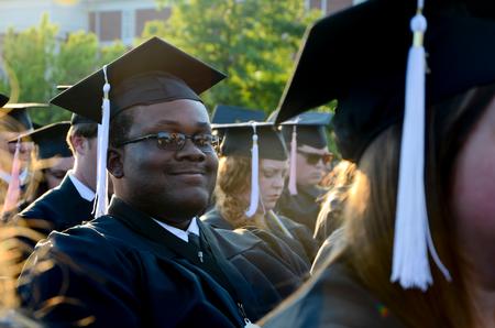 Nigel Manuel, media communications graduate, grins for a photo during spring graduation.  - Photo by Ebbie Davis