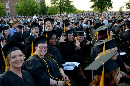 Graduates show excitement while celebrating their spring graduation.  - Photo by Ebbie Davis