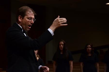 David Dennis, professor of music, conducts during the Spring Choral Concert.  - Photo by Ebbie Davis