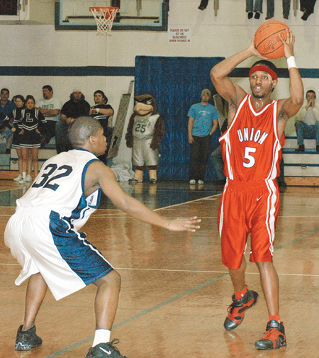 Marcus Cooper (5) surveys the floor during a Union win at Lambuth. - Photo by Kristen Hiller
