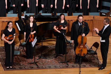 Members of the string quartet receive applause after their performance at the Spring Choral Concert. - Photo by Ebbie Davis