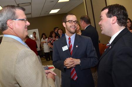 Norman Hill, chair of the university board of trustees, Landon Preston, director of donor relations, and Josh Clarke, director of alumni relations, chat together preceding the dedication ceremony of the new Hendersonville facility. - Photo by Morris Abernathy