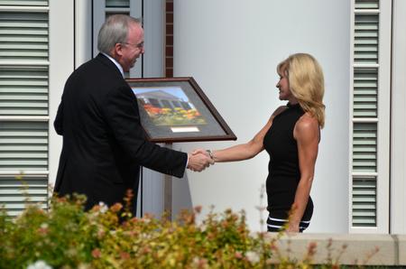 Janet Ayers receives a gift from David S. Dockery, president of the university, during the dedication of the new Hendersonville facility. - Photo by Morris Abernathy