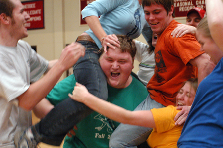 Jonathan Blair celebrates with his team, The Junior Class, shortly after serving as the base for a human stacking competition and winning that stage of the Wild and Wacky Homecoming Games.  - Photo by Kristen Nicole Sayres