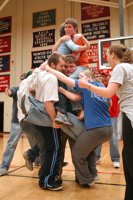 Junior Jonathan Blair looks nervous as he balances a number of students during Wild and Wacky Homecoming Games. - Photo by Kristen Nicole Sayres