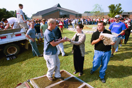 Director of Student Outreach Suzanne Mosely and Junior Youth Ministry major Bo Irvin participate in the removal of the stones from the altar at the September 11 Service of Remembrance and Response. - Photo by Jim Veneman
