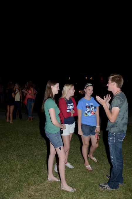 Will Harman (right), junior music major, tells a story to Kim Chesney, junior history major, Katelynn Corden, junior history major, and Anna Lewis, junior tesl major, during the Howdy Party. - Photo by Anne Richoux