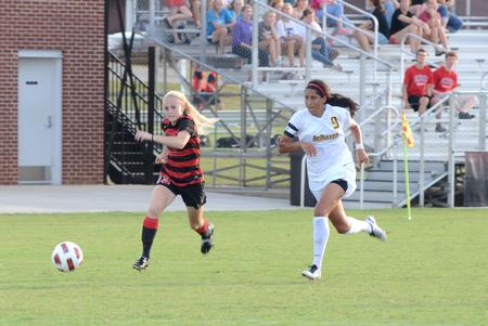 Lady Bulldog Kelsey Gilbert attacks the ball while Belhaven's defender falls behind. - Photo by Ebbie Davis