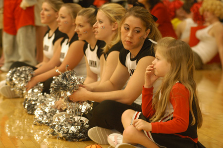 A future Bulldog cheerleader gets to sit in with the current squad during the Homecoming basketball. - Photo by Lindsay Stavish