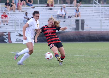 Megan Roney attacks the ball against the offense to get possession back.  - Photo by Ebbie Davis