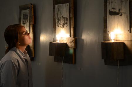 Paige Ward, shop technician in the art department, admires the Westmoreland and DePriest art exhibit showing in Union's art gallery. - Photo by Ebbie Davis