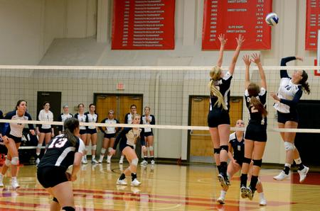 Kristin Cook, freshman psychology major, and Jami Humphries, junior media communications major, combine for a double block against the University of West Florida. - Photo by Anne Richoux