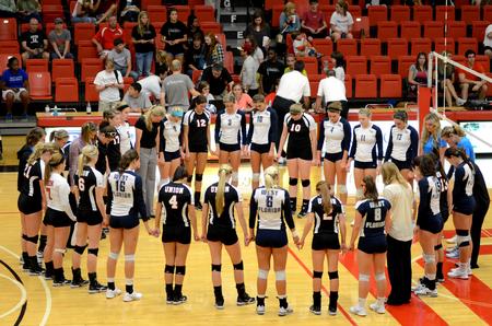 The Lady Bulldog and the University of West Florida volleyball teams join together for a time of prayer following their match. - Photo by Anne Richoux