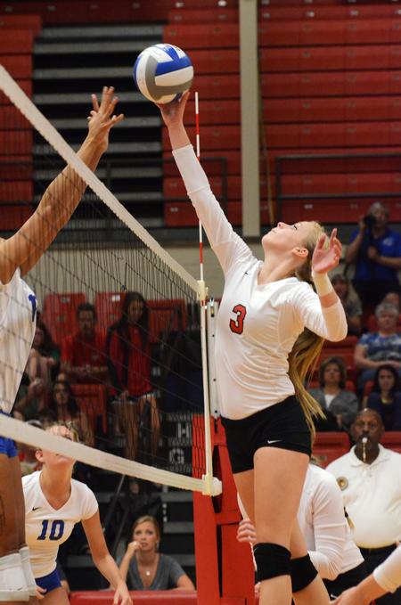 Kristin Cook, freshman psychology major, goes up to tip to ball during a game against University of Alabama-Huntsville. - Photo by Zac Calvert