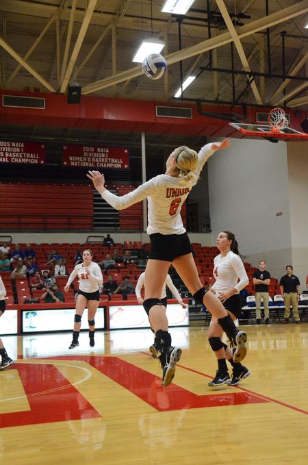 Mallory Baker, freshman business administration major, prepares to spike the ball during a match against University of Alabama-Huntsville. - Photo by Zac Calvert