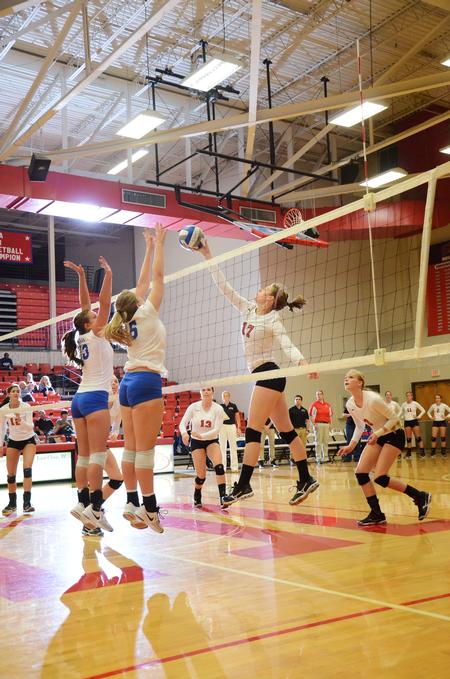 Erin Hennesy, freshman nursing major, tries to tip the ball over players from  University of Alabama-Huntsville. - Photo by Zac Calvert