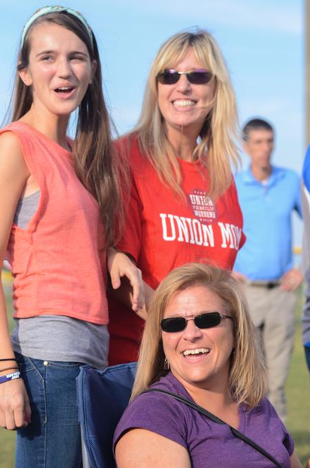 Lindsey Chesak, Cheryl Chesak, and Justine Stump cheer and watch intramural games during Family Weekend. - Photo by Zac Calvert