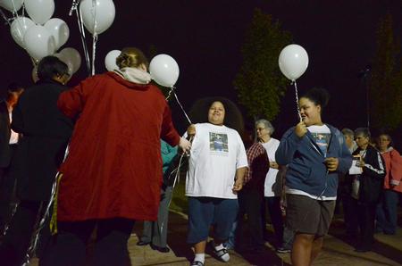 Homicide-loss survivors receive white balloons at the fifth annual Remember Me Commemorative Walk. The balloons were released in honor of lost loved ones. - Photo by Jacob Moore
