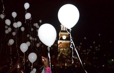 Homicide-loss survivors release white balloons at the end of the fifth annual Remember Me Commemorative Walk. - Photo by Jacob Moore