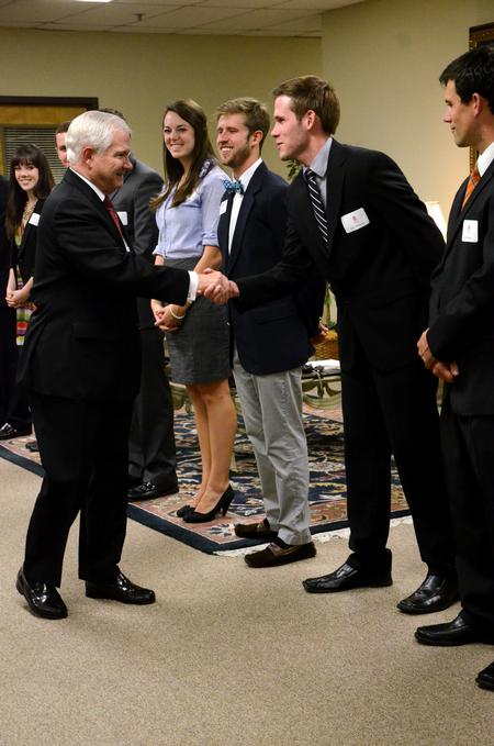 SAC president Jeff Thompson, senior digital media studies major, introduces himself to Former Secretary of Defense Robert M. Gates during a reception before the 15th Annual Scholarship Banquet.  - Photo by Anne Richoux