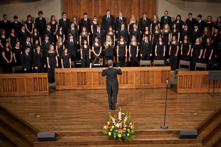 Chris Mathews, associate professor of music and department chair, conducts the Union University Singers in a performance at First Baptist Church. - Photo by Ryan Oetting