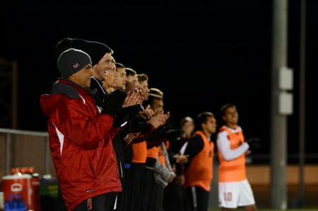Clovis Simas, J. Landham, and the Bulldog soccer team cheer for the starting players at the beginning of their last home game of the season.  - Photo by Anne Richoux