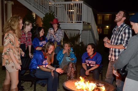 Students and staff gather around a fire pit outside of the Bowld Student Commons during Costume Coffee House. - Photo by Anne Richoux