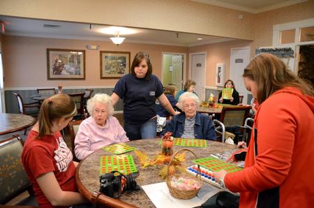 Students talk with residents at Alexandria Place, an assisted living home, during Campus and Community Day.  - Photo by Anne Richoux