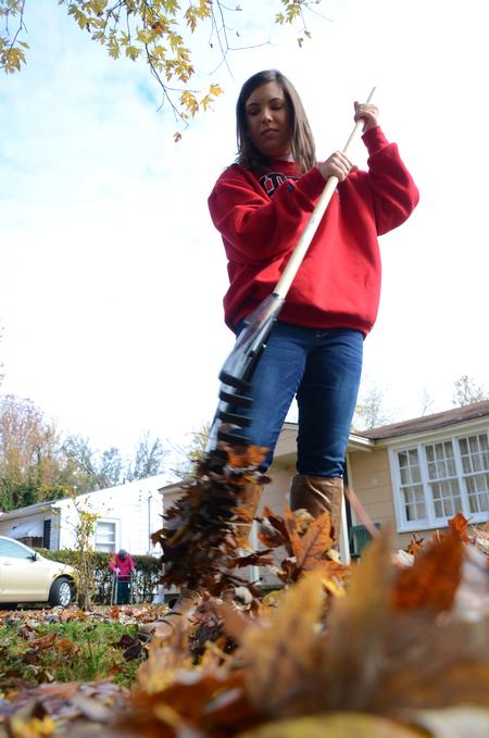 Kelsey Woods, freshman chemistry major, begins to rake at the home of a elderly family in South Jackson during the tenth annual Campus and Community Day.  - Photo by Ebbie Davis
