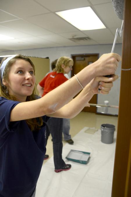 Laura Little, sophomore Christian ministry and missions major, rolls the youth room walls at Cornerstone Baptist Church during the tenth annual Campus and Community Day.  - Photo by Ebbie Davis