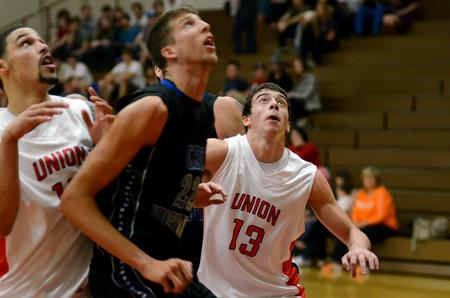 Anthony Freeman and Giorgi Koguashvili work against a Central Baptist College player for rebounding position in the Bulldogs season opener.  - Photo by Anne Richoux
