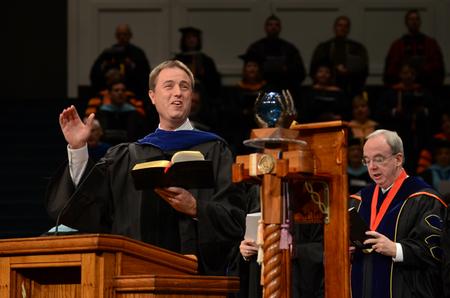 Chris Mathews, associate professor of music and department chair, leads graduates and their friends and families in a Christmas hymn during Fall Commencement. - Photo by Jacob Moore
